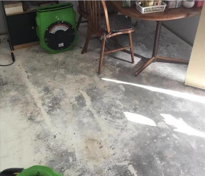 a bare floor is shown after flooding with water removal equipment