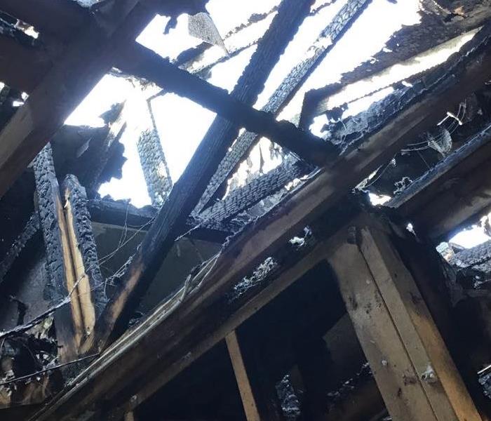 Photo of roof damage following a fire from a stove